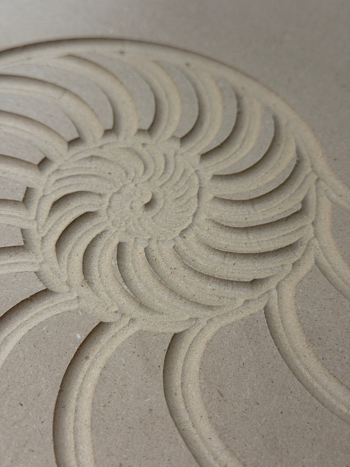 First test cut of the client-supplied nautilus artwork, showing the fine spiral lines carved out as wide open pockets