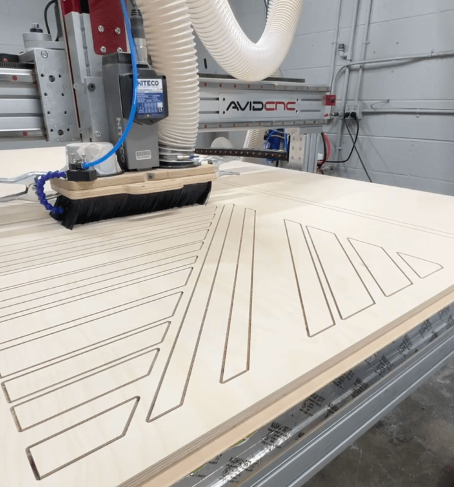 CNC machine milling top-layer pieces with a precision downcut bit for clean top edges