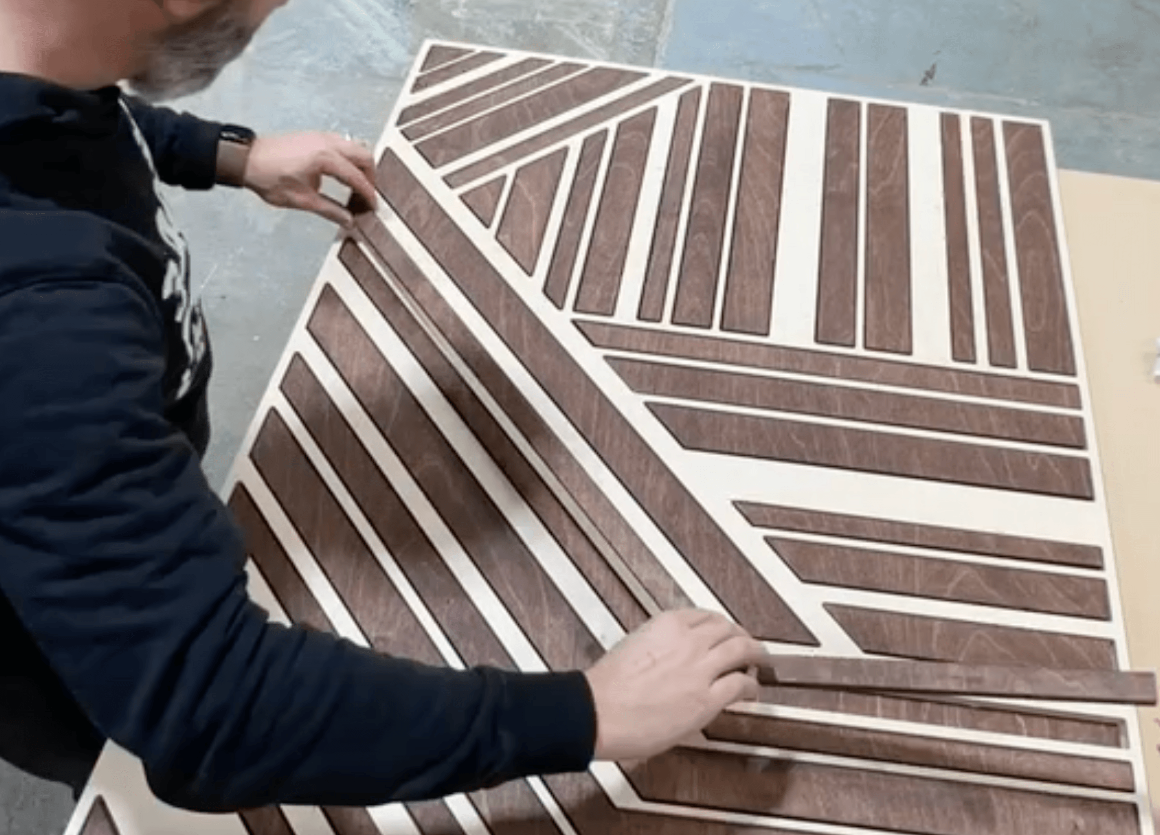 Top-layer pieces being glued onto the backing board during assembly
