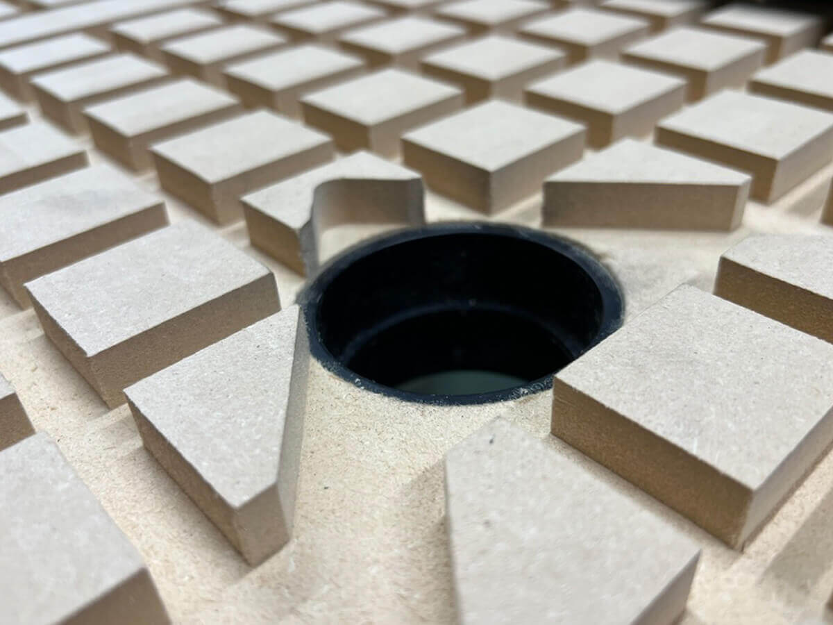 A zoomed in view of a custom cut vaccuum table insert